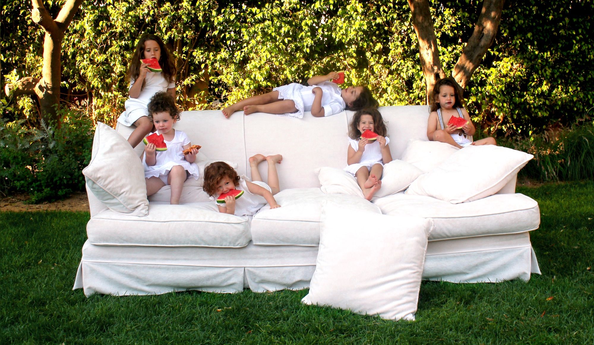 Children on a white flocked sofa